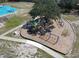 Aerial view of the community playground with swings, slides, and other fun play equipment at 2113 Golf Manor Blvd, Valrico, FL 33596