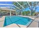 A lovely screened-in pool, patio, and backyard with lush green trees create a tropical oasis at 2113 Golf Manor Blvd, Valrico, FL 33596