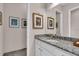 Bathroom with granite countertops, framed prints, and white cabinetry in a modern design at 2165 Hollow Forest Ct, Wesley Chapel, FL 33543