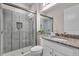 Modern bathroom showcasing a glass shower and granite countertops with a clean, contemporary design at 2165 Hollow Forest Ct, Wesley Chapel, FL 33543