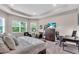 Spacious bedroom with large windows, tray ceiling, and sitting area at 2165 Hollow Forest Ct, Wesley Chapel, FL 33543