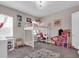 Bright bedroom featuring playful decor, a loft bed with desk, and a whimsical color palette at 2165 Hollow Forest Ct, Wesley Chapel, FL 33543