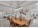 Dining room features a wood table, decorative lighting, and an open floor plan at 2165 Hollow Forest Ct, Wesley Chapel, FL 33543