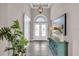 Bright foyer with high ceilings, stylish lighting, and decorative accents at 2165 Hollow Forest Ct, Wesley Chapel, FL 33543