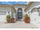 Home's entrance featuring a gated walkway and double garage doors at 2165 Hollow Forest Ct, Wesley Chapel, FL 33543