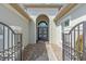Gated front entrance featuring a brick walkway and arched doorway at 2165 Hollow Forest Ct, Wesley Chapel, FL 33543