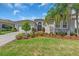 Charming home with a lush lawn, well-manicured landscaping, and a welcoming front entrance at 2165 Hollow Forest Ct, Wesley Chapel, FL 33543