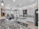 Well-equipped kitchen with a center island, granite countertops, and stainless steel appliances at 2165 Hollow Forest Ct, Wesley Chapel, FL 33543