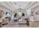 Open living room featuring a large sectional sofa and sliding glass doors to the outdoors at 2165 Hollow Forest Ct, Wesley Chapel, FL 33543