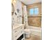 Bright bathroom featuring stylish vanity, tub, and decorative turtle and anchor wall hangings at 2501 Crescent Dr, Largo, FL 33770