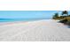 Beautiful white sand beach with clear blue water and a tranquil coastal view at 2501 Crescent Dr, Largo, FL 33770