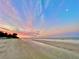 Beautiful sunset view over a tranquil beach with calm waters and soft, sandy shores at 2501 Crescent Dr, Largo, FL 33770