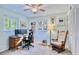 Bedroom features a large window, a ceiling fan, and a comfortable rocking chair at 2501 Crescent Dr, Largo, FL 33770