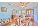 Bright dining room featuring light blue walls, wood floors, and a large window at 2501 Crescent Dr, Largo, FL 33770