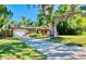 Charming single-story home with mature trees, inviting curb appeal, and a well-manicured front yard at 2501 Crescent Dr, Largo, FL 33770