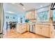 Well-lit kitchen featuring light wood cabinets, modern stainless steel appliances, and an adjacent dining area at 2501 Crescent Dr, Largo, FL 33770