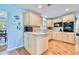 Bright kitchen boasts wood floors, light wood cabinetry, and modern appliances at 2501 Crescent Dr, Largo, FL 33770