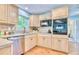 Galley kitchen features bright cabinets, stainless steel appliances, and neutral countertops at 2501 Crescent Dr, Largo, FL 33770