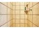 Enclosed shower stall with light beige tiles and convenient shelving at 2501 Crescent Dr, Largo, FL 33770