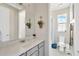 Bright bathroom with a large mirror, white countertop, and neutral-toned walls, creating a clean and fresh space at 2511 Early Dawn Ct, Valrico, FL 33594