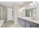Modern bathroom featuring a double vanity, tile flooring, and a glass-enclosed shower, offering a spa-like experience at 2511 Early Dawn Ct, Valrico, FL 33594