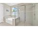 Luxurious bathroom with a soaking tub and a glass-enclosed shower, perfect for relaxation and rejuvenation at 2511 Early Dawn Ct, Valrico, FL 33594