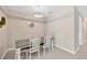 A well-lit dining area showcases a rustic table, seating for six, and a modern light fixture at 2511 Early Dawn Ct, Valrico, FL 33594