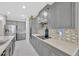 Well-appointed kitchen with gray cabinetry, stainless steel appliances, and view of open concept living, offers modern elegance at 2511 Early Dawn Ct, Valrico, FL 33594