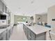 Open kitchen area features an expansive island, stainless appliances, and seamless flow into the dining and living spaces at 2511 Early Dawn Ct, Valrico, FL 33594