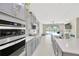 Spacious kitchen has gray cabinetry, a modern cooktop, and a large island, all with views to the backyard pool area at 2511 Early Dawn Ct, Valrico, FL 33594