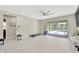 Bright living room featuring tile floors, neutral walls, and sliding glass doors to the pool at 2511 Early Dawn Ct, Valrico, FL 33594