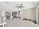 Expansive living space with modern ceiling fan, tile flooring, and open access to kitchen and dining at 2511 Early Dawn Ct, Valrico, FL 33594