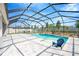 Backyard oasis featuring sparkling pool, screened enclosure, beautiful patio, and ample seating at 2511 Early Dawn Ct, Valrico, FL 33594