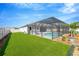 A beautiful screened-in pool, patio, and well-maintained lawn are the highlights of this backyard at 2511 Early Dawn Ct, Valrico, FL 33594