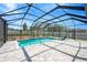 Inviting backyard pool featuring screened-in enclosure, new tile work, and lush landscaping at 2511 Early Dawn Ct, Valrico, FL 33594