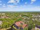 Scenic aerial view shows the condo building nestled within a lush green environment and water feature near an open horizon at 2650 Countryside Blvd # C203, Clearwater, FL 33761