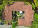 Unique aerial view of building showing courtyard with trees and landscaping, complemented by terra cotta roof and greenery at 2650 Countryside Blvd # C203, Clearwater, FL 33761