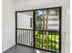 A cozy screened balcony offers views of tropical landscaping at 2650 Countryside Blvd # C203, Clearwater, FL 33761