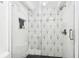 Upgraded bathroom featuring a frameless glass shower and tile flooring at 2650 Countryside Blvd # C203, Clearwater, FL 33761