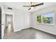 Well-lit bedroom with a ceiling fan, closet and window view at 2650 Countryside Blvd # C203, Clearwater, FL 33761
