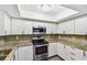 Updated kitchen with granite countertops, stainless steel oven and white cabinets at 2650 Countryside Blvd # C203, Clearwater, FL 33761