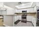 Updated kitchen with granite countertops, stainless steel appliances and modern cabinets at 2650 Countryside Blvd # C203, Clearwater, FL 33761