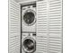 Stacked laundry units are neatly tucked away behind white shutter doors at 2650 Countryside Blvd # C203, Clearwater, FL 33761