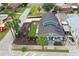 Aerial view of a charming two-story blue home, showcasing its well-manicured yard and neighborhood setting at 2704 W Main St, Tampa, FL 33607