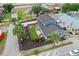 Aerial view of a charming home with a landscaped backyard, including an outdoor seating area with firepit at 2704 W Main St, Tampa, FL 33607