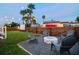 Backyard features a stone fire pit, an outdoor theater screen, and plenty of seating at 2704 W Main St, Tampa, FL 33607