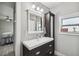 Bathroom with sleek vanity, large mirror, and connects to a bedroom at 2704 W Main St, Tampa, FL 33607