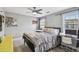 Neutral bedroom with a ceiling fan, two windows and a work space at 2704 W Main St, Tampa, FL 33607