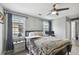 Comfortable bedroom featuring a ceiling fan, two windows and a bedside table at 2704 W Main St, Tampa, FL 33607