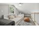 Comfortable bedroom space with window, twin bed, and a cozy brown beanbag chair at 2704 W Main St, Tampa, FL 33607